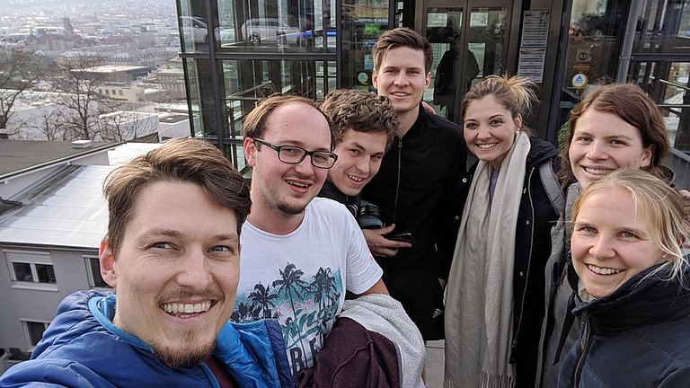 Sieben Macher der JIN stehen vor dem Aufzug der Jugendherberge in Stuttgart.