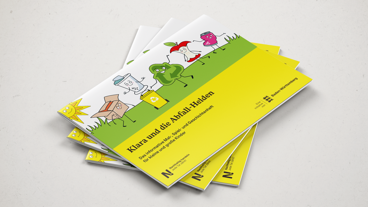 Drei Malbücher, Klara und die Abfallhelden, liegen übereinander auf einer Arbeitsfläche.