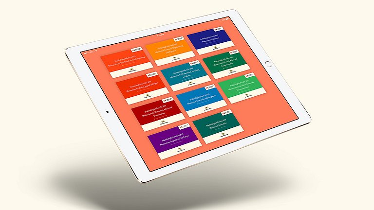 Auf einem Tablet sind vom Nachhaltigkeitsbericht 2019 des Landes Baden-Württemberg die Titelseiten der zehn Berichtsteile der Minsterien sowie des übergreifenden Berichtsteils abgebildet.