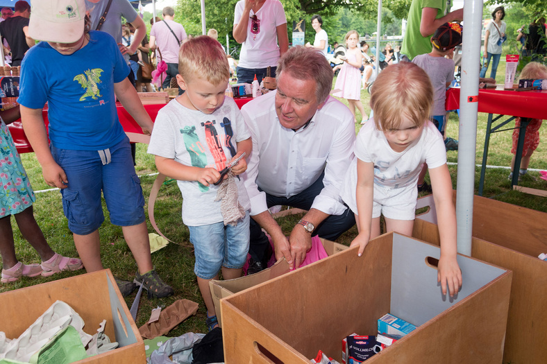 Herr Minister Franz Untersteller unterhält sich mit paar spielenden Kindern während einer Mitmachaktion