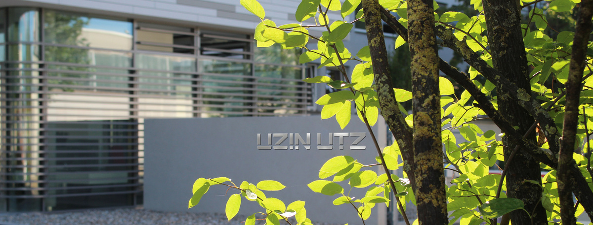 Der Hauptsitz der Uzin Utz AG befindet sich in einem modernen Kubus-Gebäude mit großen Glasfronten.