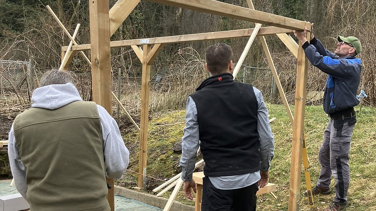 Eltern bauen die Pergola.