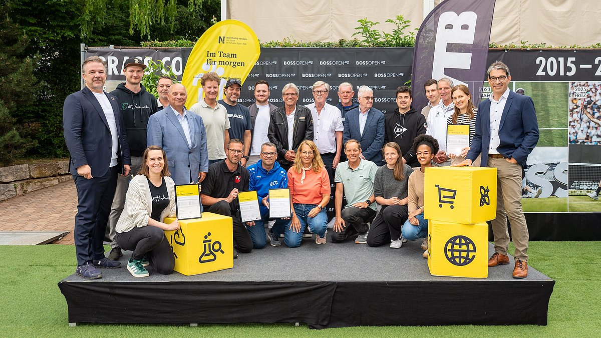 Alle neu zur N!-Charta Sport beigetretenen Vereine gemeinsam mit Staatssekretär Dr. Andre Baumann auf der Bühne bei den BOSS OPEN.