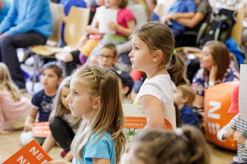 Gespannte Kinder warten auf die Verleihung des ersten Platz