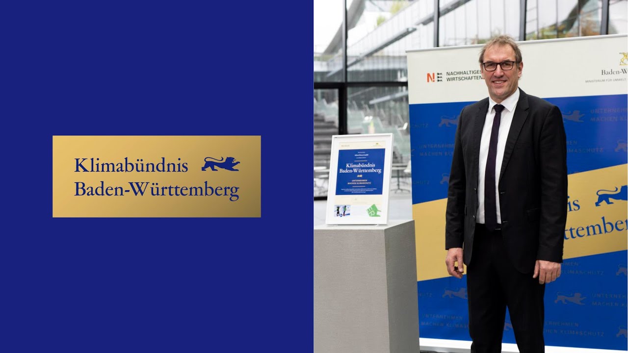 Links das Logo in gold und blau "Klimabündnis Baden-Württemberg, Unternehmen machen Klimaschutz". Rechts Wolfgang Roßkopf.