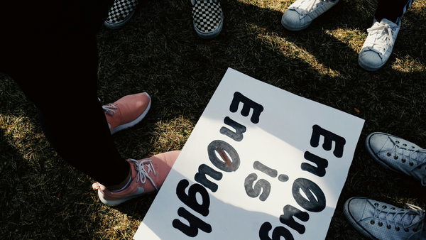 Ein Plakat auf dem Boden mit der Aufschrift "enough is enough"